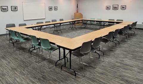 Tables arranged in an enclosed square with chairs on outside of square