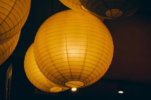 A photograph of 2 lit paper lanterns.