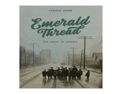 A colorized photograph of small children standing in the middle of a mostly empty street wired for cable cars with the words "Tim Bohen" and "Emerald Thread: The Irish in Buffalo" along the top